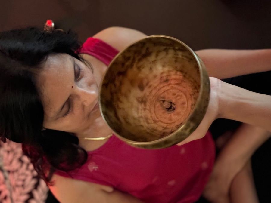 A singing bowl held above a resting student