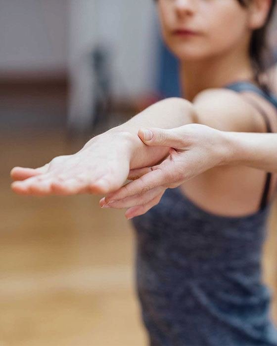 A therapist gently guiding a student’s arm